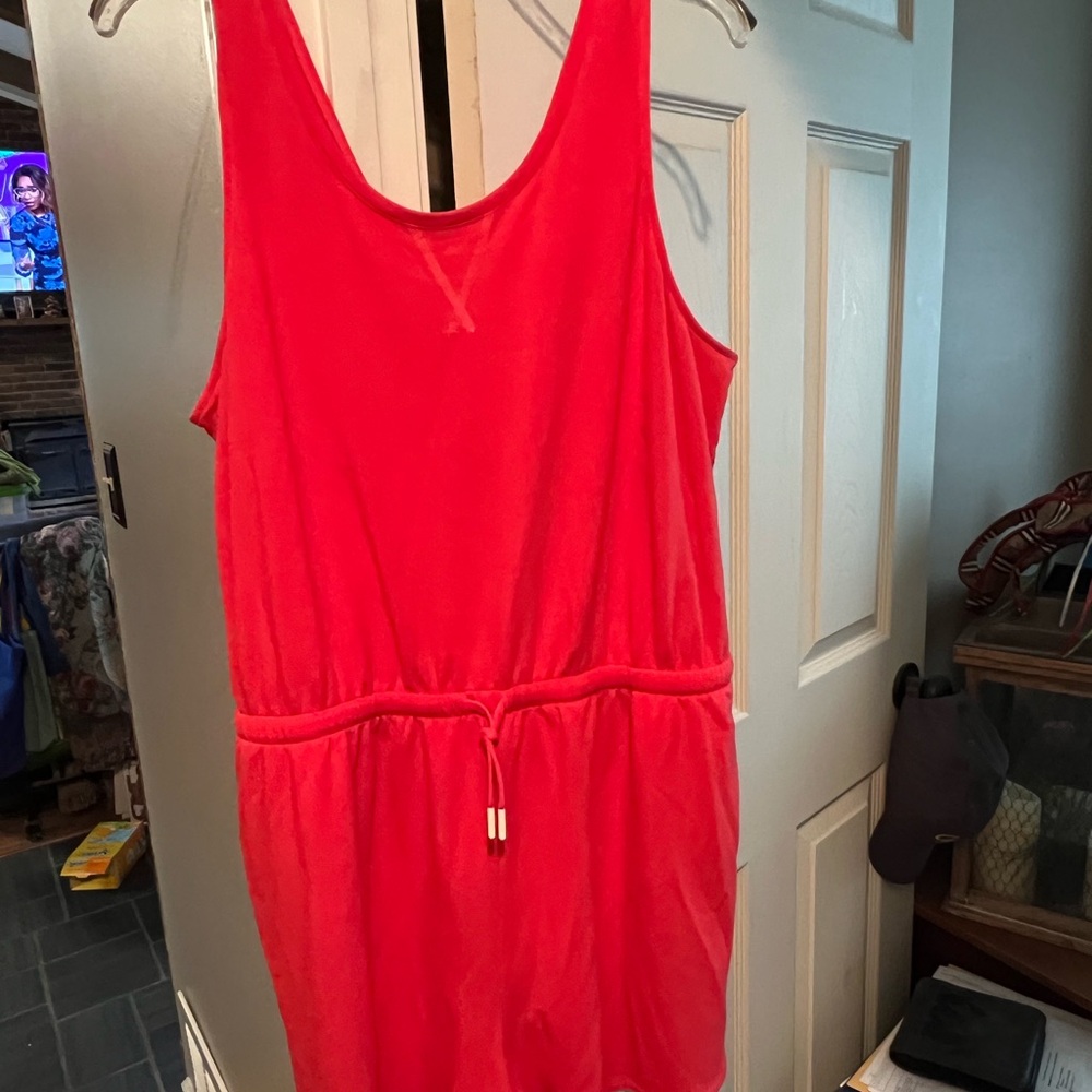 Orange Red Sleeveless romper shorts with pockets and draw string waist.